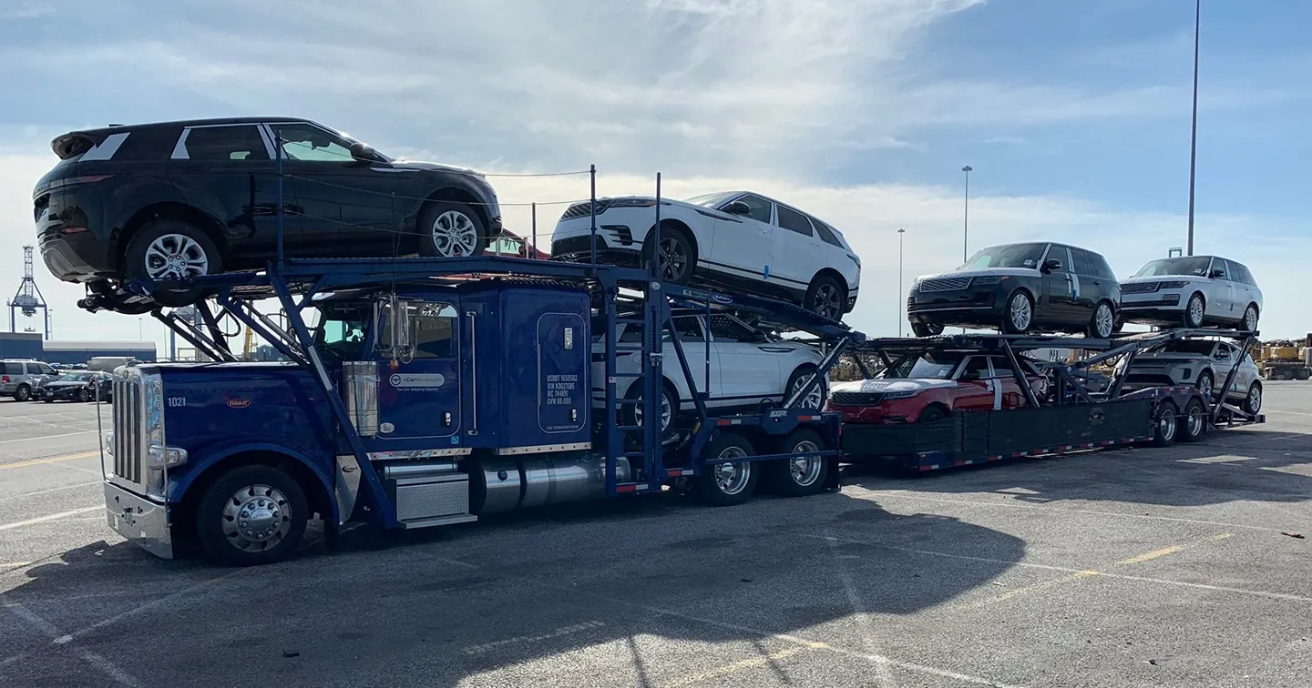 eCarMover car carrier truck loaded with SUVs in a port parking lot