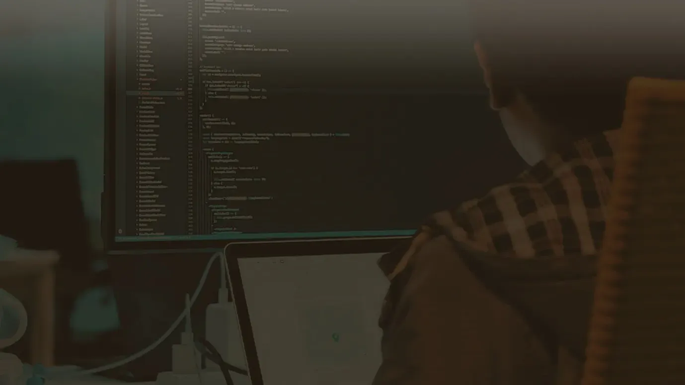 Developer working at a monitor full of code, WayMark Infotech story cover