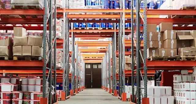 Warehouse aisle with tall pallet racks stocked with boxes and containers