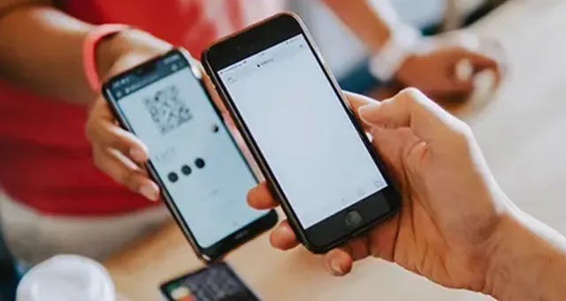 Two smartphones side by side, one displaying a QR code to be scanned